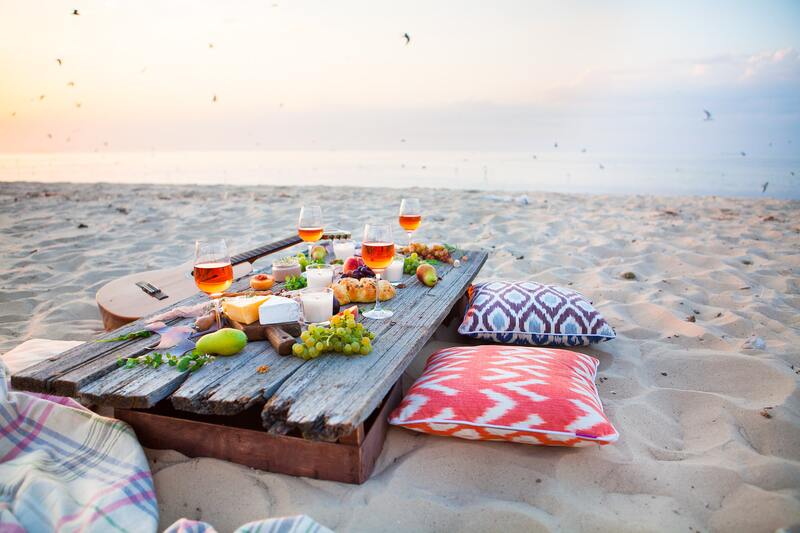 resort snack by the ocean with wine at sunset